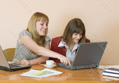 Girls work sitting at a table