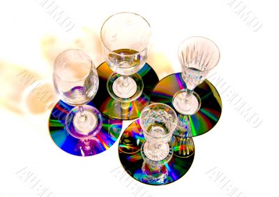 Four glasses on small colorful shiny trays.