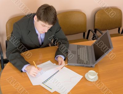 Businessman on a workplace with the laptop