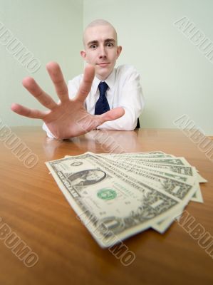 Man reaches for a batch of money