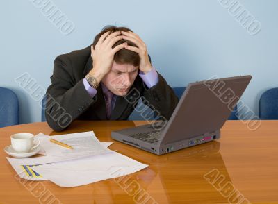 Businessman on a workplace with the laptop
