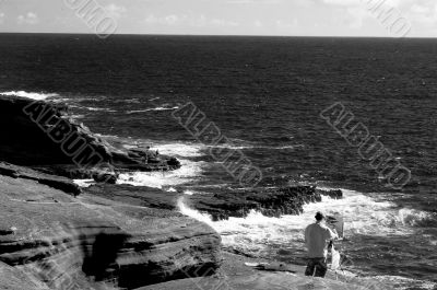 Artist painting at Makapuu Beach Hawaii sepia