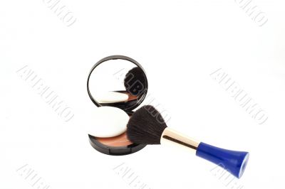 face powder with mirror and a brush