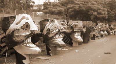 Ravana head effigies on the street sepia