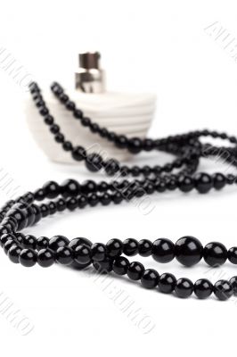 black necklace and parfume