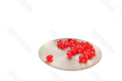 vitamin pills on a steel round plate