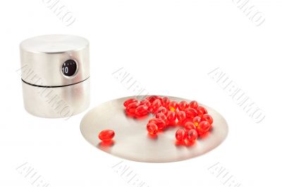 vitamin pills on a round plate and timer