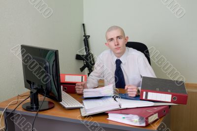 Chief on a workplace with a rifle on a background