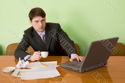 Businessman on a workplace with the laptop