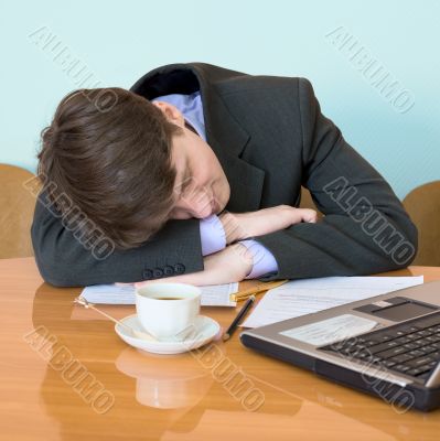 Businessman has fallen asleep sitting at meeting