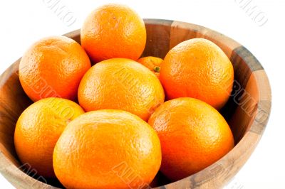 wood dish full with oranges