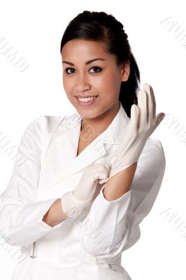 Portrait of a beautifull Indonesian nurse putting gloves on