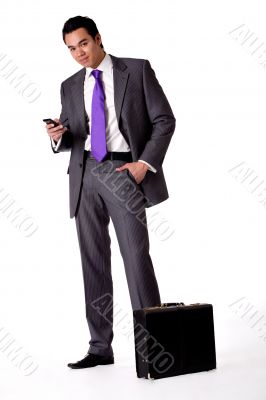 Portrait of a strong young indonesian man in a suit with phone