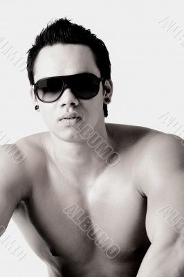 Portrait of a well build bare Indonesian man  with sunglasses