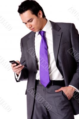 Strong young indonesian man in a suit checking his phone