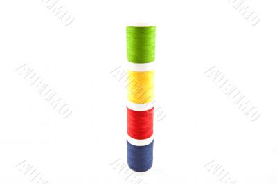 four multicolored spools on a white background