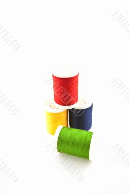 four multicolored spools