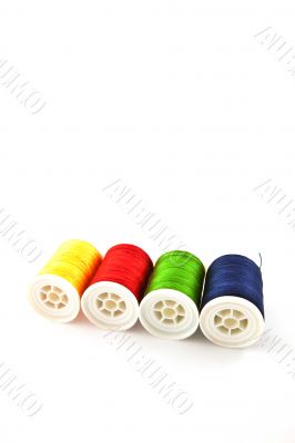 four multicolored spools four multicolored spools