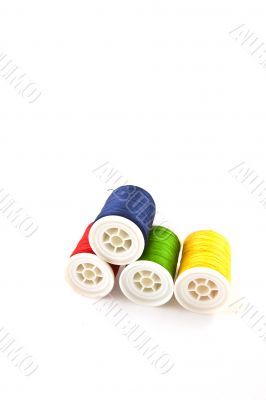 four multicolored spools