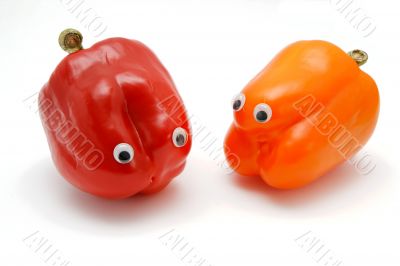 Two funny bell peppers with eyes on white Two funny bell peppers with eyes on white