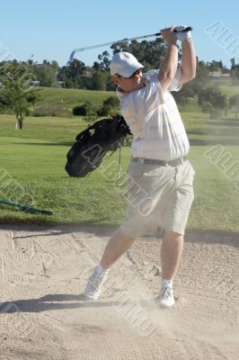 Golfer in sand bunker
