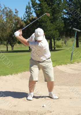 Golfer in the sand bunker
