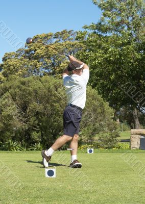 Golfer hitting the ball off the tee box