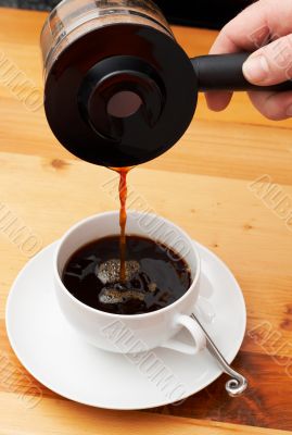 Closeup of coffee being poured into the cup