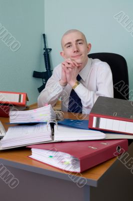 Self-satisfied worker of office armed with a rifle