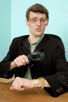 Person view a watch through a magnifier Person view a watch through a magnifier
