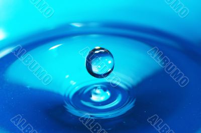 The drop of water, falls downwards...