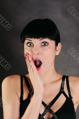 surprised woman over dark background