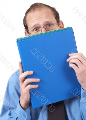 Businessman hiding behind the folder