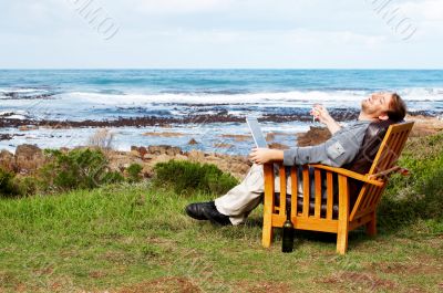 Young man laughing outdoors