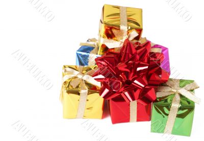 Stack of gift boxes and bow on white