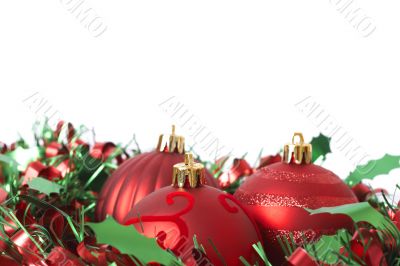 Three Red Christmas baubles on tinsel Three Red Christmas baubles on tinsel