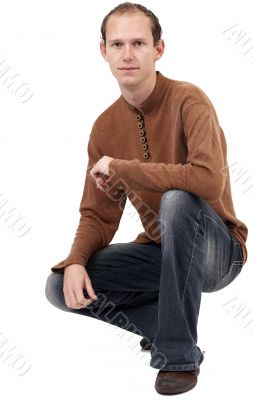 Young caucasian man sitting down