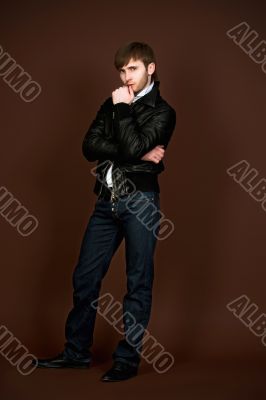 man in leather jacket with crossed hands