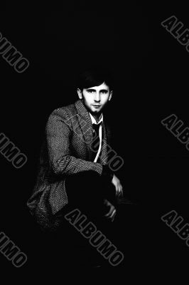 man in striped modern coat sitting man in striped modern coat sitting