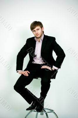 man in suite sitting on chair