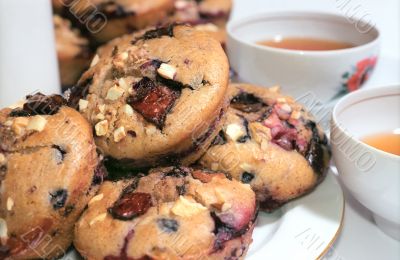 Muffins cakes on the plate and tea cups Muffins cakes on the plate and tea cups