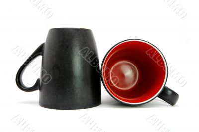 Two black cups down and on side isolated Two black cups down and on side isolated