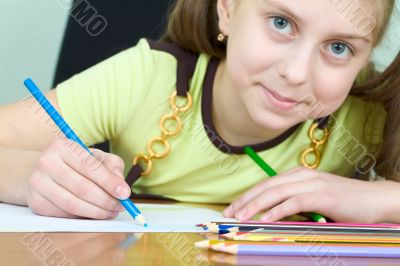 Girl holding a blue pencil Girl holding a blue pencil