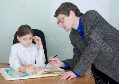 Tutor and schoolgirl with atlas