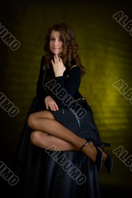 Beauty girl in black on dark background