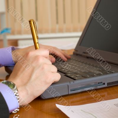 Laptop and hands with a pen Laptop and hands with a pen