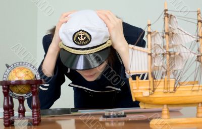 Sad woman in a sea uniform at table