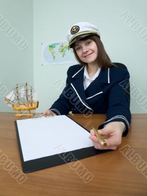 Woman in a sea uniform at table with tablet