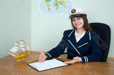Woman in a sea uniform at table with tablet