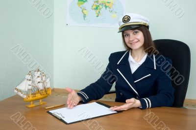 Woman in a sea uniform at table with tablet Woman in a sea uniform at table with tablet